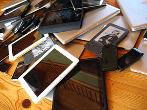 English: A pile of mobile devices including sm...
