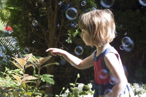 Child chasing bubbles